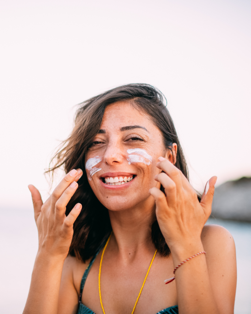 Protecting Her Glow: A Moment of Self-Care - Seaflora Skincare Someone applying natural sun shield for UV protection.