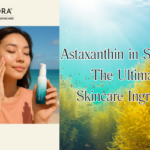 Woman applying Seaflora Natural Sun Shield on her face with underwater seaweed and blog title overlay: "Astaxanthin in seaweed: the ultimate skincare ingredient"; Seaflora logo in black at the top left.