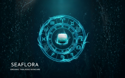 Stylized zodiac wheel illustration where the constellation patterns are formed by glowing, vibrant strands of Pacific seaweeds against a deep blue-green, starry ocean background. A Seaflora product jar is integrated into the center.